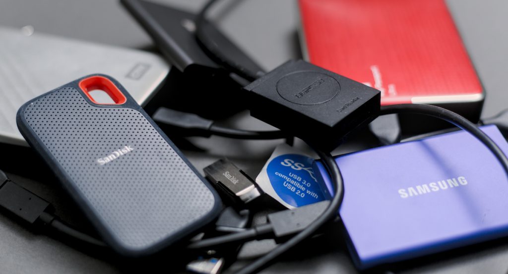 A pile of hard drives and storage media